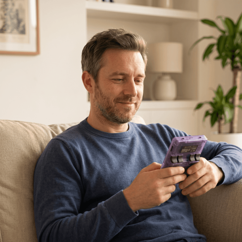 Person playing the Jszbdf Pro 2.0 R36S retro gaming console at home